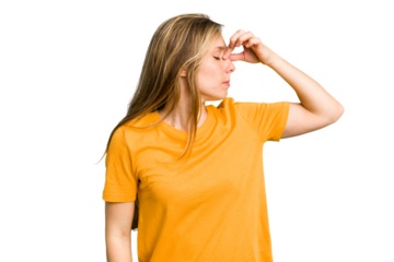 Young caucasian woman cutout isolated having a head ache, touching front of the face.