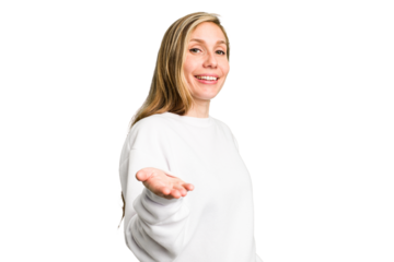 Young caucasian woman cutout isolated stretching hand at camera in greeting gesture.