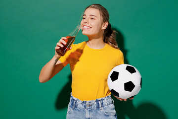 Young overjoyed woman fan wear basic yellow t-shirt cheer up support football sport team hold in...