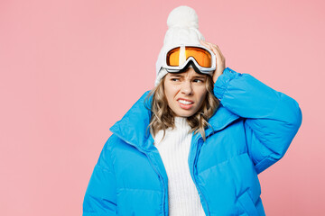 Snowboarder worried sad woman wears blue suit goggles mask hat ski padded jacket hold head look...
