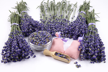 Bouquets of fresh lavender, potpourri of dried lavender in a glass bowls, lavender in small bags for aromatherapy lie on a white table