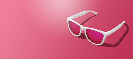 Banner of white sunglasses on magenta background with hard light scene and copy space. Studio shot of modern sunglasses on Viva Magenta tones background.