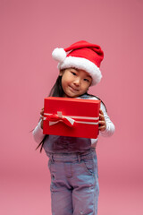 Cute little girl in santa hat looking happy and sweet