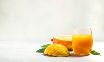 mango juice and fresh fruits on a light background. Long banner format