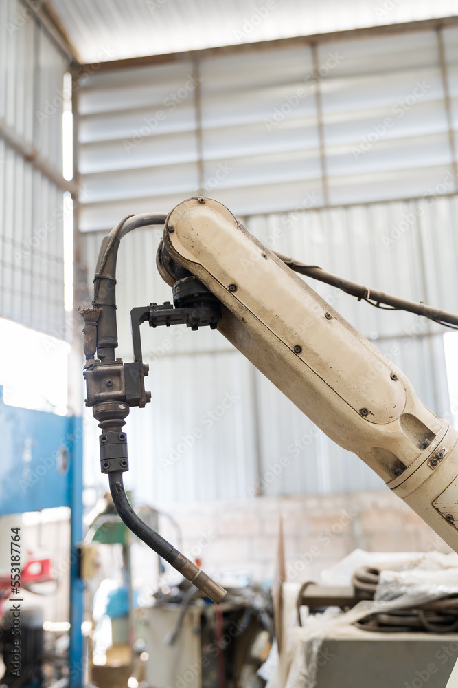Aufkleber Close-up of automatic robot arm system welding machine in the industry factory. Industry robot manufacturing technology