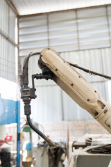Close-up of automatic robot arm system welding machine in the industry factory. Industry robot manufacturing technology