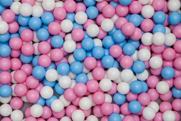 plastic balls for seaballs. pink, blue, white colored toys. pool children's playroom.