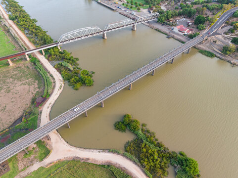 Aerial view of bridges crossing a wide brown river