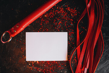 card mockup, mockup of a white sheet of paper bdsm toys, red leather whip on a black background with red glitter © alekuwka83