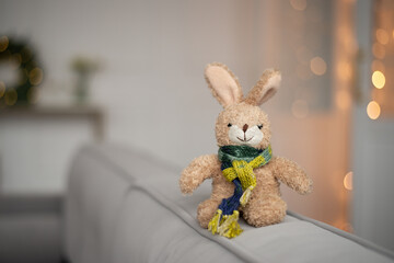 An old favorite toy is a rabbit in a scarf, on Christmas Eve. 2023 is the year of the rabbit. The concept of a greeting card for sick children for the new year. Sore throat