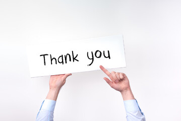 two hands hold up a sign that says thank you