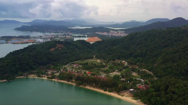 Drone forward flying capturing Teluk Batik beach with marina island and damar laut in the background, straits of malacca, Lumut, Perak, Malaysia, Southeast Asia.