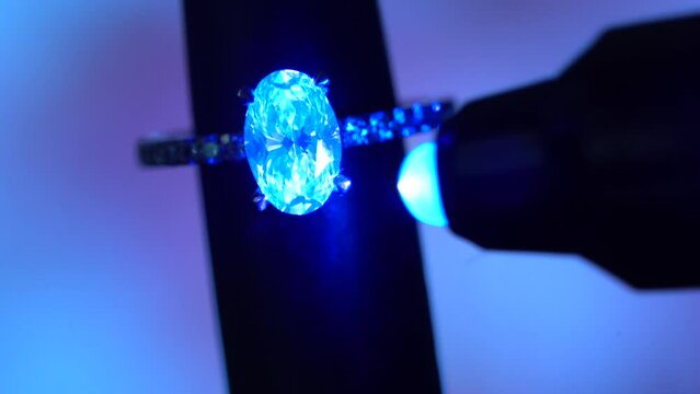Beautiful Fluorescence Glow of Natural Solitaire Diamonds On Engagement Ring under UV light