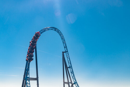 Ride roller coaster in blurred motion on sky background in amusement park
