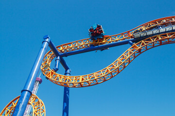 Ride roller coaster in blurred motion on sky background in amusement park