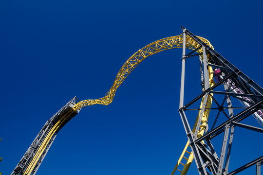 Helsinki, Finland - 24 June 2022: View of Linnanmaki amusement park with empty ride roller coaster Ukko on blue sky background.