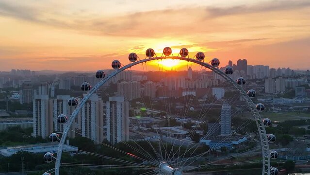Sunset sky at Sao Paulo Brazil. Major Ferris Wheel  Entertainment of Latin America at downtown Sao Paulo Brazil. Sunset at Ferris wheel at amusement park. Entertainment attraction. Vila Lobos Park. 