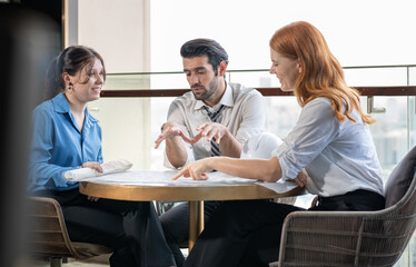 Architect meeting with client explaining construction blueprint for building renovation project. Engineer manager discussion on renovation service agreement deal with customer. Construction industry.