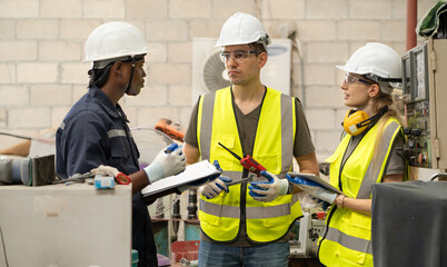 Male industrial engineer manager working with engineering team at production factory in safety equipment technology. Manufacturing technician meeting brainstorming with colleague at workshop facility