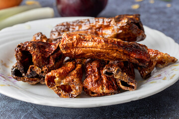 Dry hot pepper fries on wooden background.