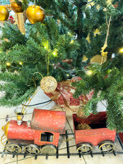 Decorated Christmas, New Year tree with a toy train for children.