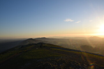 the top of the Malvern hills on a misty day during sunset