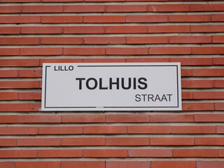 Street name with inscription, Lillo, tolhuisstraat which means toll house in the porlder village of Lillo in Belgium