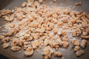 Delicious homemade roasted cashews, candied and caramelized on baking paper in the Christmas season.