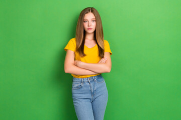 Portrait of calm serious young person folded arms isolated on bright green color background