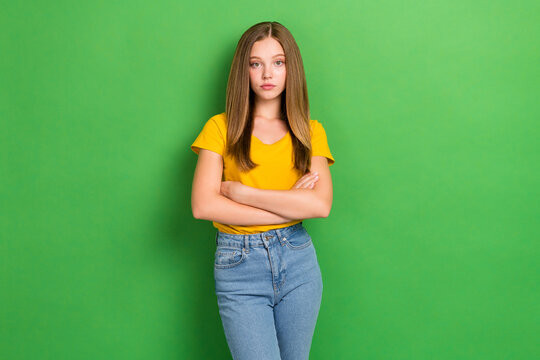 Portrait Of Calm Serious Young Person Folded Arms Isolated On Bright Green Color Background