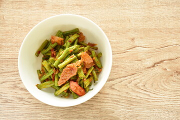 spicy stir fried slice yard long bean with fat pork in curry sauce on bowl