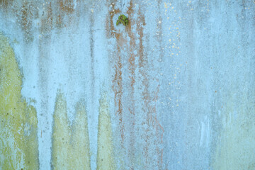 old wooden plank wall with old faded peeling green, yellow paint