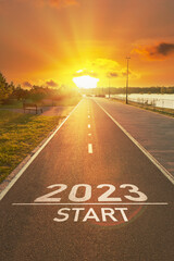 New Year 2023 start beginnings. 2023 year number is written on the asphalt on the free sports path in bright sun rays. Concept for planning future your life, business ideas. Motivational inscription