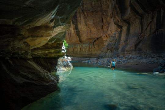 Hiker walking in the Narrows, Zion National park, USA