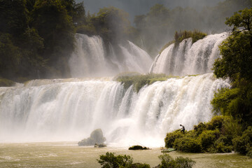 Close up on a fisherman at the waterfall of Ban Gioc Detian between Vietnam and China