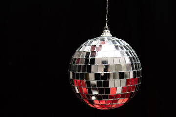 silver mirror balls on red gifts and black background