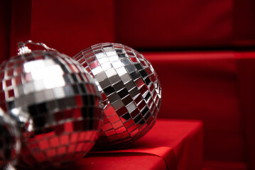 silver mirror balls on red gifts and black background