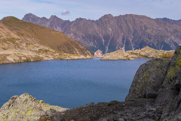 Alpine mountain hut by the lake, summer