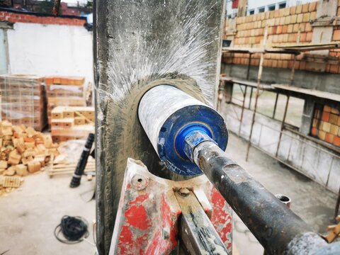 Hole cutting machine. Drilling concrete with an industrial drilling machine with an industrial diamond grain. Core drills used in ring cutters for reinforced concrete columns