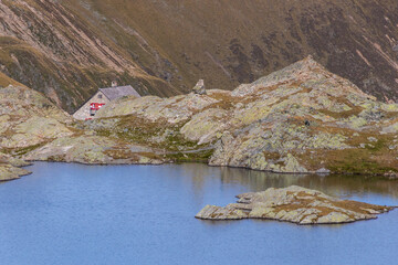 Alpine mountain hut by the lake, summer