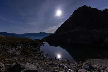 Full moon reflection in the alpine lake