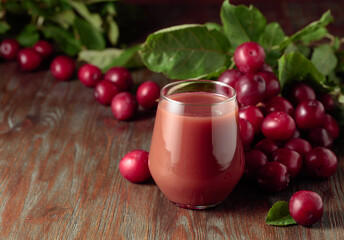 Red plums and a glass of plum juice.