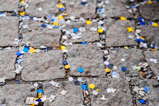Yellow and blue confetti like the flag of Ukraine scattered on the paving stones. Victory for Ukraine, peace, no war.