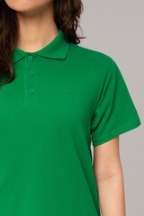 blank green polo shirt on woman isolated on white background. Close-up Mock-Up