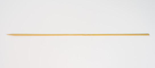 Obraz premium single long bamboo barbeque and grilling skewers isolated on a white background