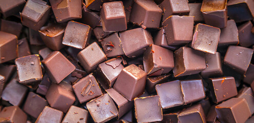 Background Fresh dark chocolate parts from the top view. close-up Chocolate chunk and cocoa background