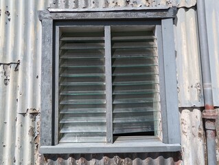 A close up view of a louvre window in the corrugated exterior to the mould loft building which was...