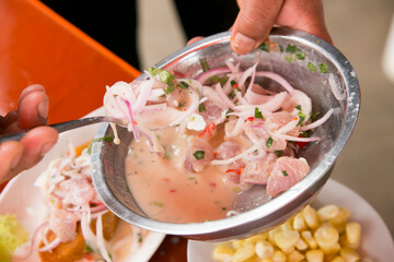 Preparing a delicious Peruvian sea bass ceviche in the fishing port of Chorríos in Lima.