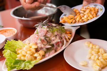 Preparing a delicious Peruvian sea bass ceviche in the fishing port of Chorríos in Lima.
