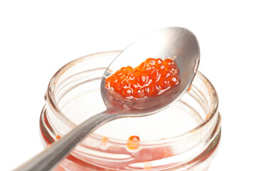 Glass jar and spoon with delicious red caviar isolated on white background.